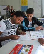 Wielu uchodźców stara się opanować język niemiecki przy pomocy uczniów lokalnych szkół
