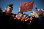 Działacze Komunistycznej Partii Rosji na placu Czerwonym zawiązują czerwone chustki na szyi młodych pionierów, maj 2022 r.
