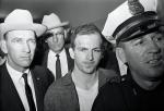 Dwa dni po aresztowaniu Lee Harvey Oswald (w środku) został postrzelony przez właściciela klubu nocnego Jacka Ruby'ego