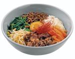 Bibimbap  to gorący ryż mieszany z mięsem  i warzywami oraz surowym żółtkiem