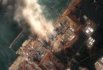 *Elektrownia Fukushima widziana z kosmosu. Na zdjęciu: zniszczony blok numer 1 siłowni  i płonący po eksplozji blok nr 3